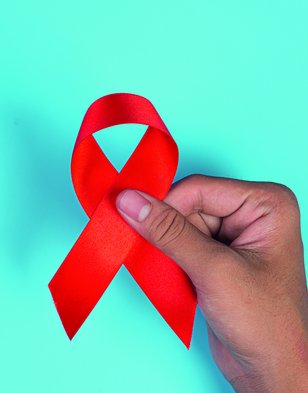 woman-hand-holding-red-ribbon-hiv-awareness-concept-world-aids-day-world-sexual-health-day